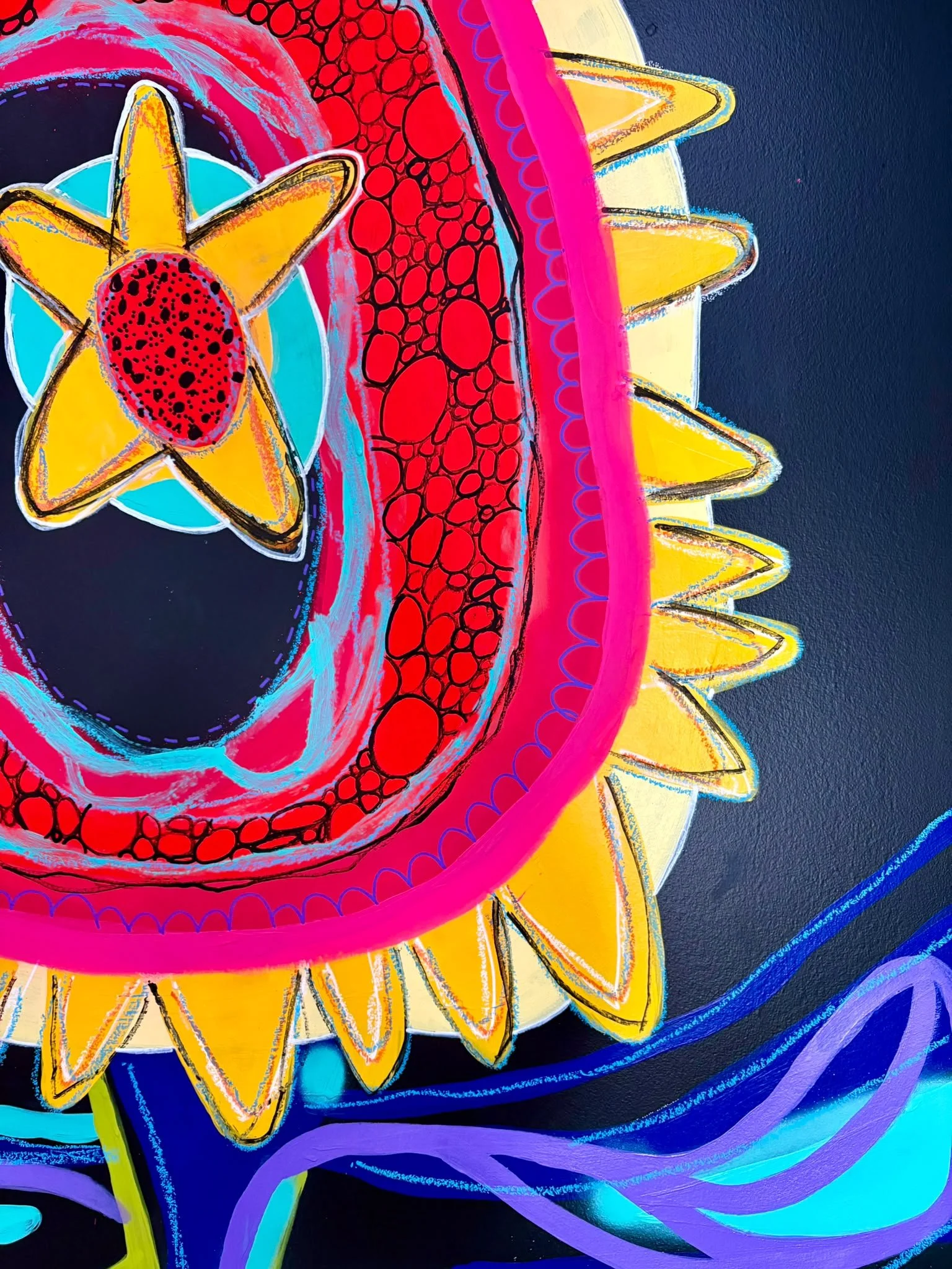 Close-up of a colorful, neon-style, psychedelic artwork featuring a stylized sunflower with yellow petals and a red center, surrounded by abstract swirling shapes in vibrant blue, purple, pink, and green colors.