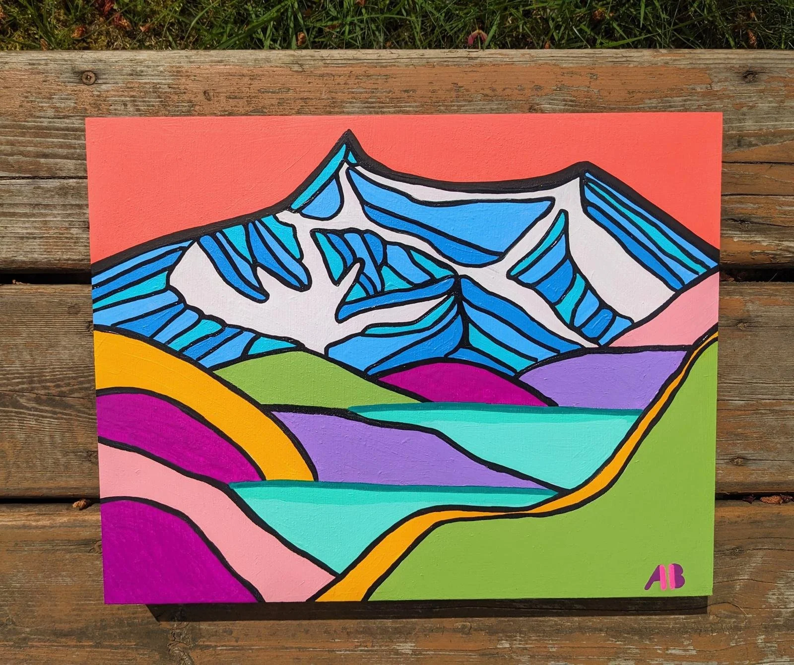 A colorful abstract painting of mountains with snow caps, rolling hills, and fields, depicted in bold black outlines and vibrant colors including blue, green, purple, pink, yellow, and orange, with an orange sky in the background.