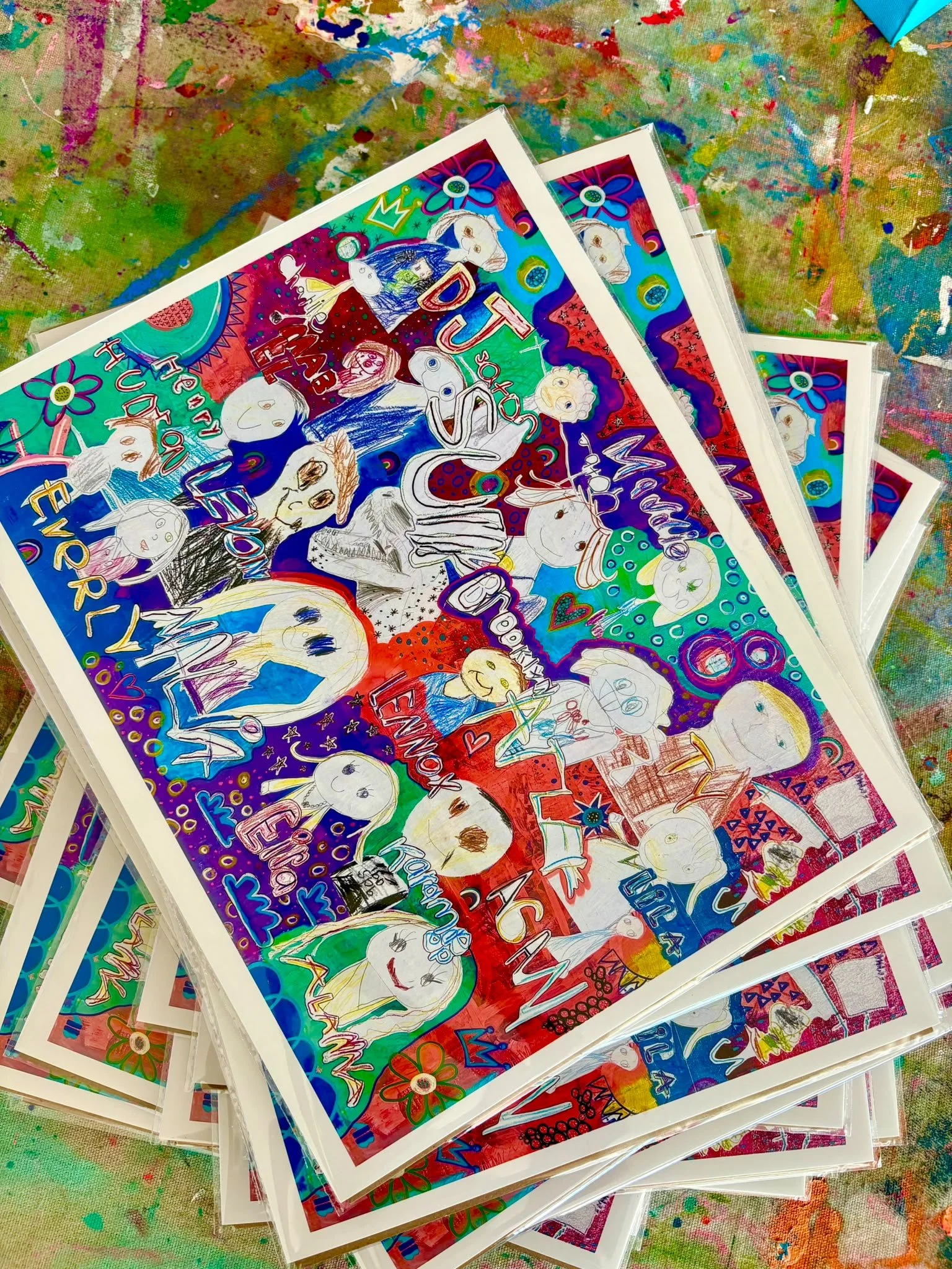 Colorful artwork featuring various hand-drawn characters, animals, and words like 'love,' 'peace,' and 'hope,' with a background of vibrant abstract colors and patterns.