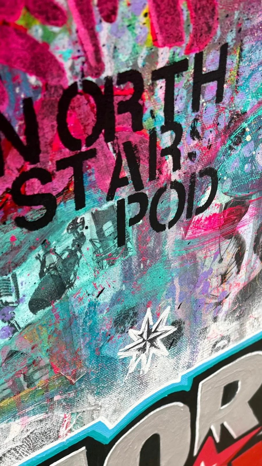 Close-up of a colorful graffiti-style artwork with abstract shapes, splashes of pink, blue, and purple, and black text that reads 'STORY' and 'POP'.