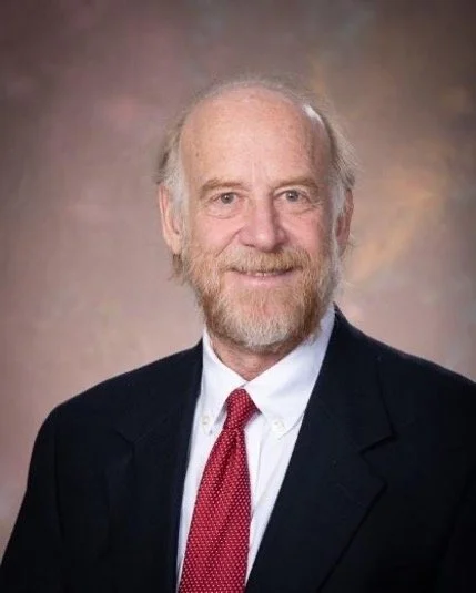 Headshot of Douglas Shapiro wearing dark suit and red tie