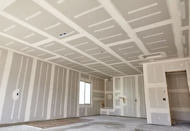 Empty room under construction with unfinished drywall and a window.