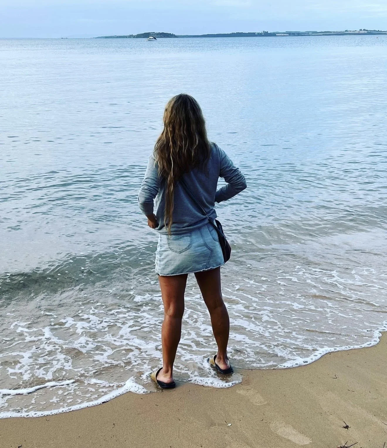 Woman standing by the ocean