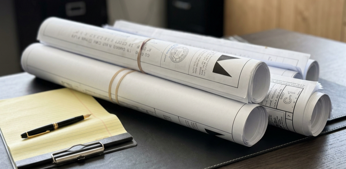Moses Architecture plans on desk.