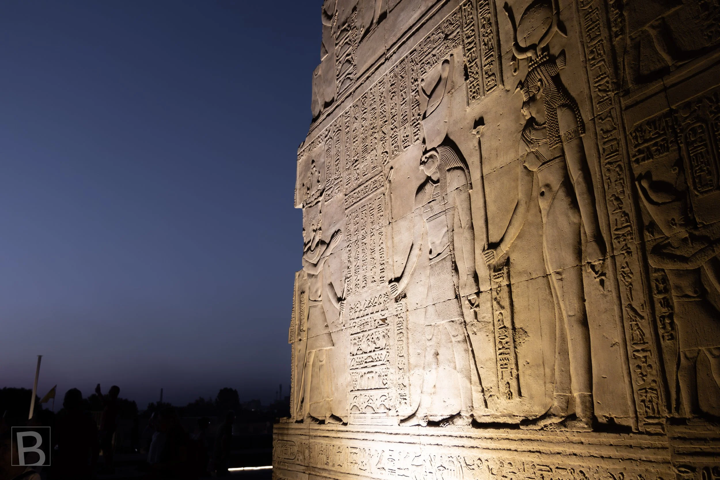 Raking light brings ancient narratives into relief across a monumental
surface of carved stone.
