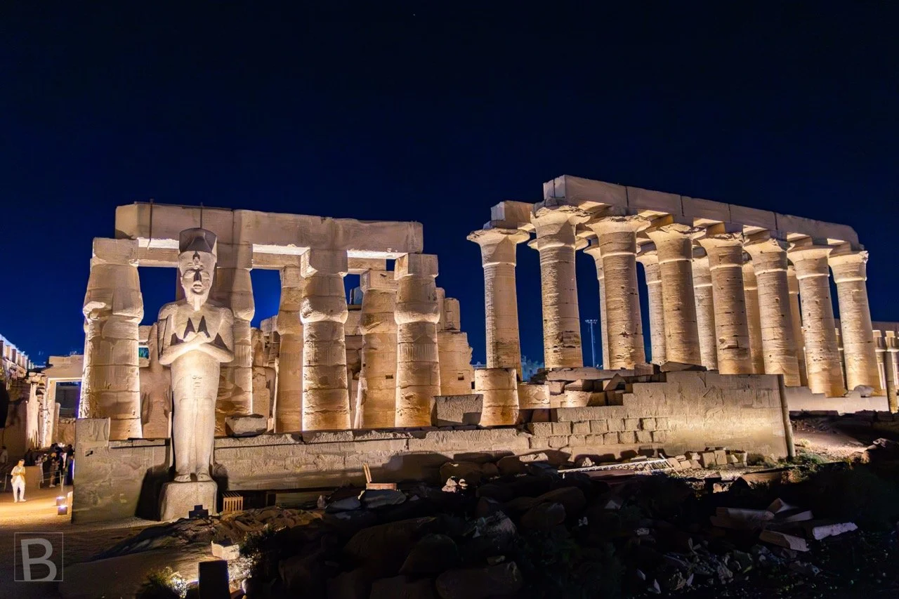 Night lighting reveals the layered procession of courts, colonnades
and royal sculpture at Luxor Temple.