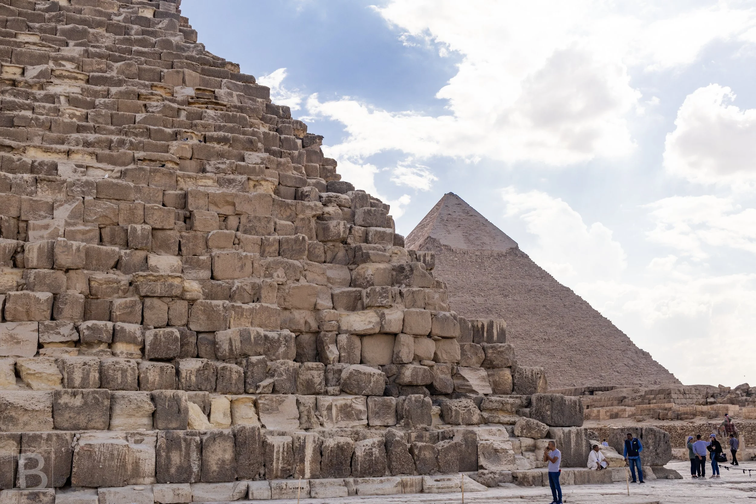 Close stonework reveals the scale and irregular texture hidden within
the pyramids' precise silhouettes.