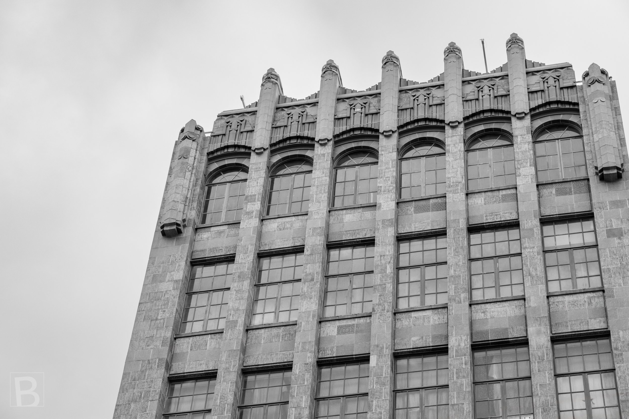 Strong masonry ribs and stacked window bays give an older city
building a distinctly modern graphic rhythm.