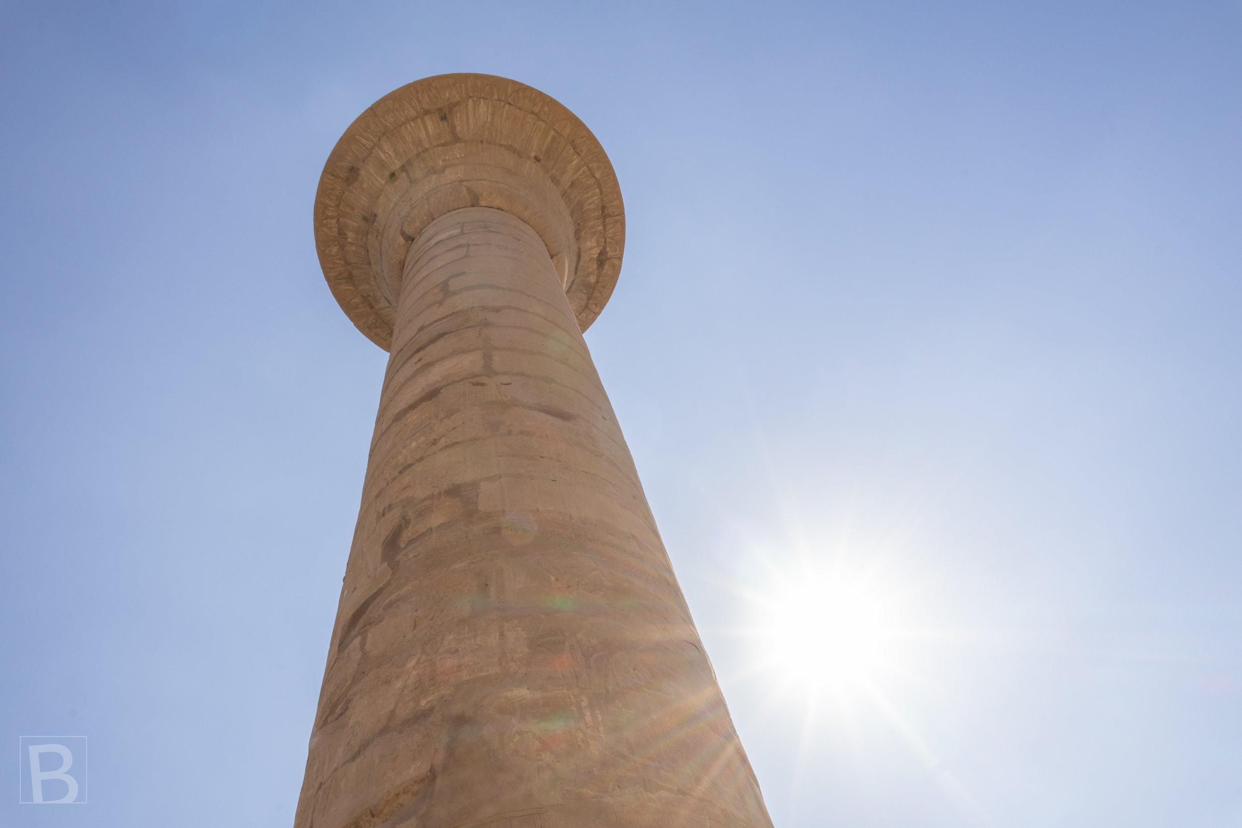Seen from below, the flared capital and tapering shaft transform a
temple column into a monumental silhouette.