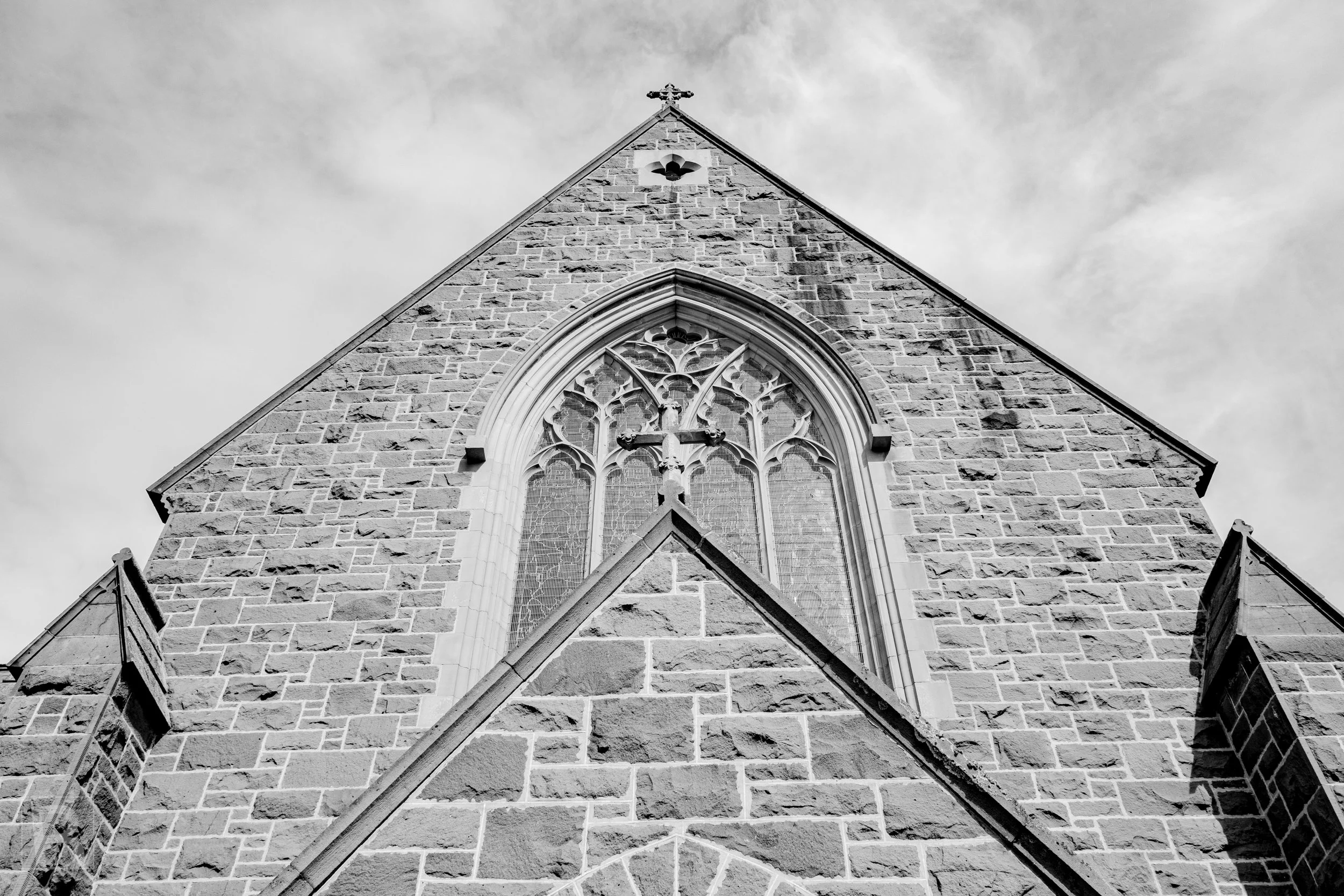 Rough stone, pointed arches and delicate tracery draw the eye
upward through a restrained study of Gothic church architecture.