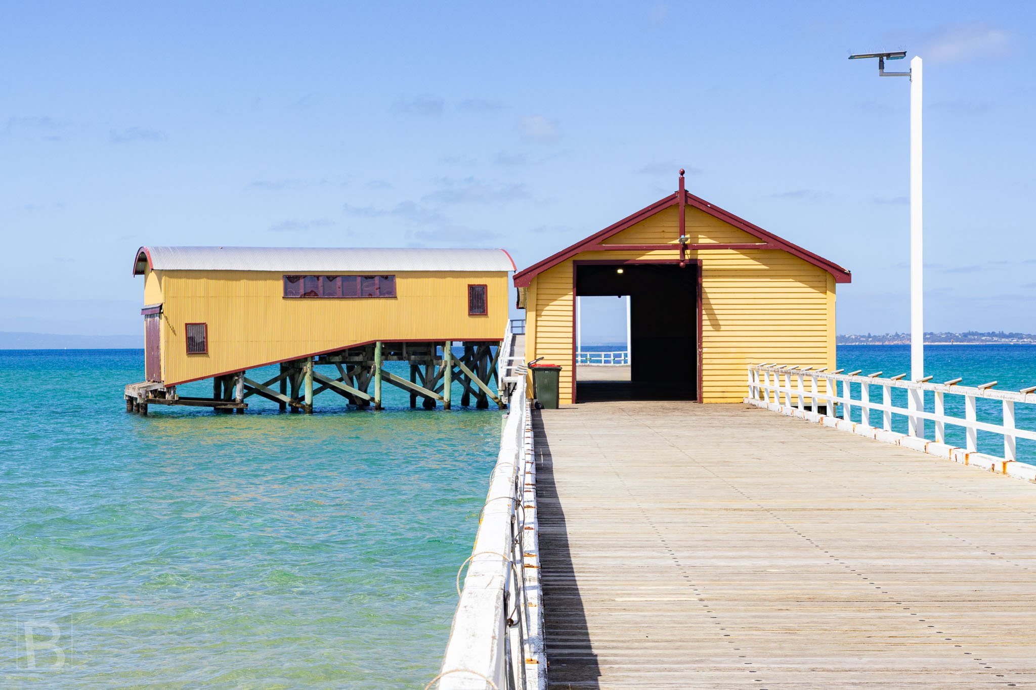 The restored timber sheds of Queenscliff Pier bring colour and
maritime history to a long structure reaching into Port Phillip Bay.