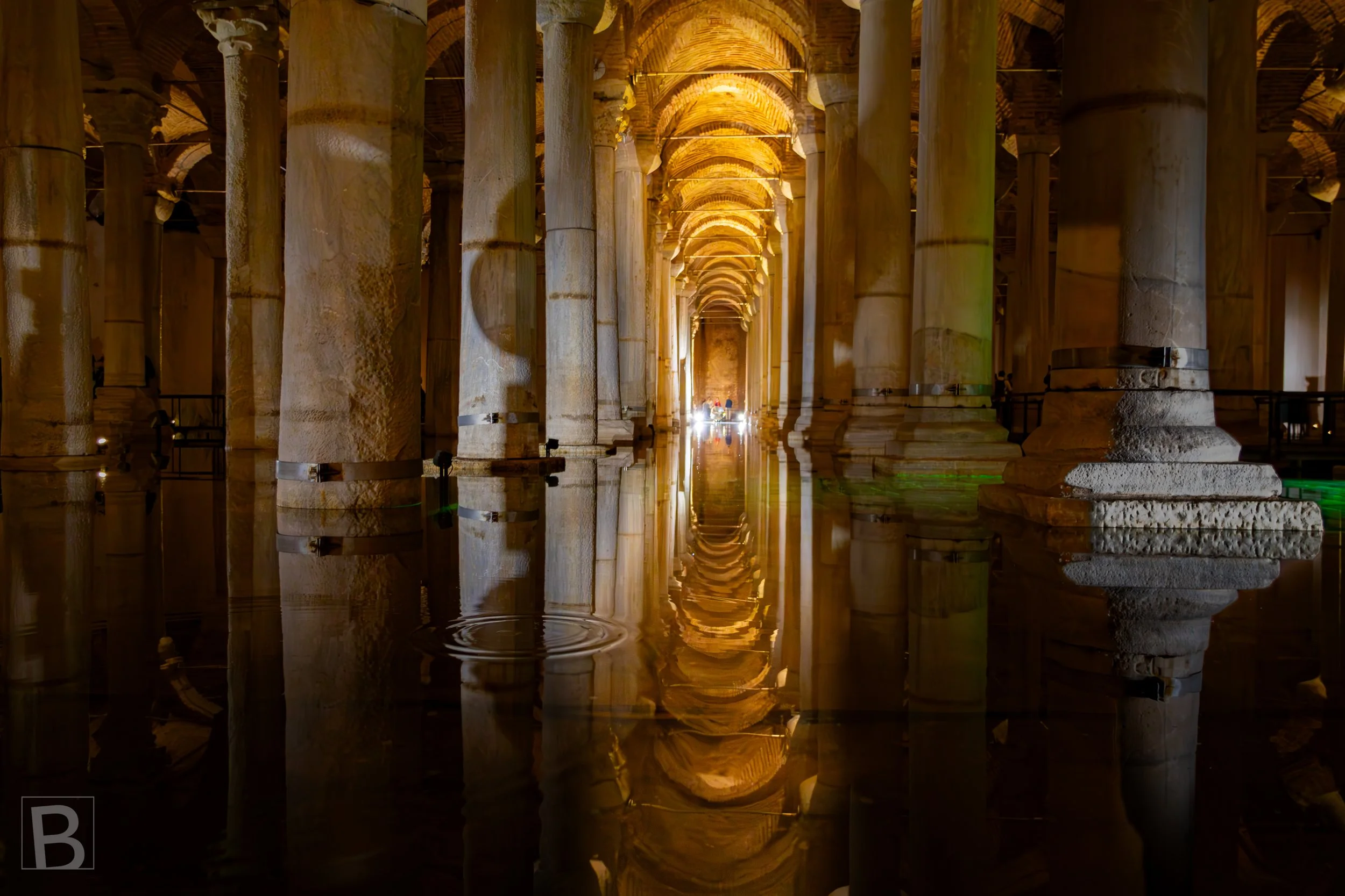 Warm light and mirror-like water extend the ancient underground
colonnade into a seemingly endless passage.
