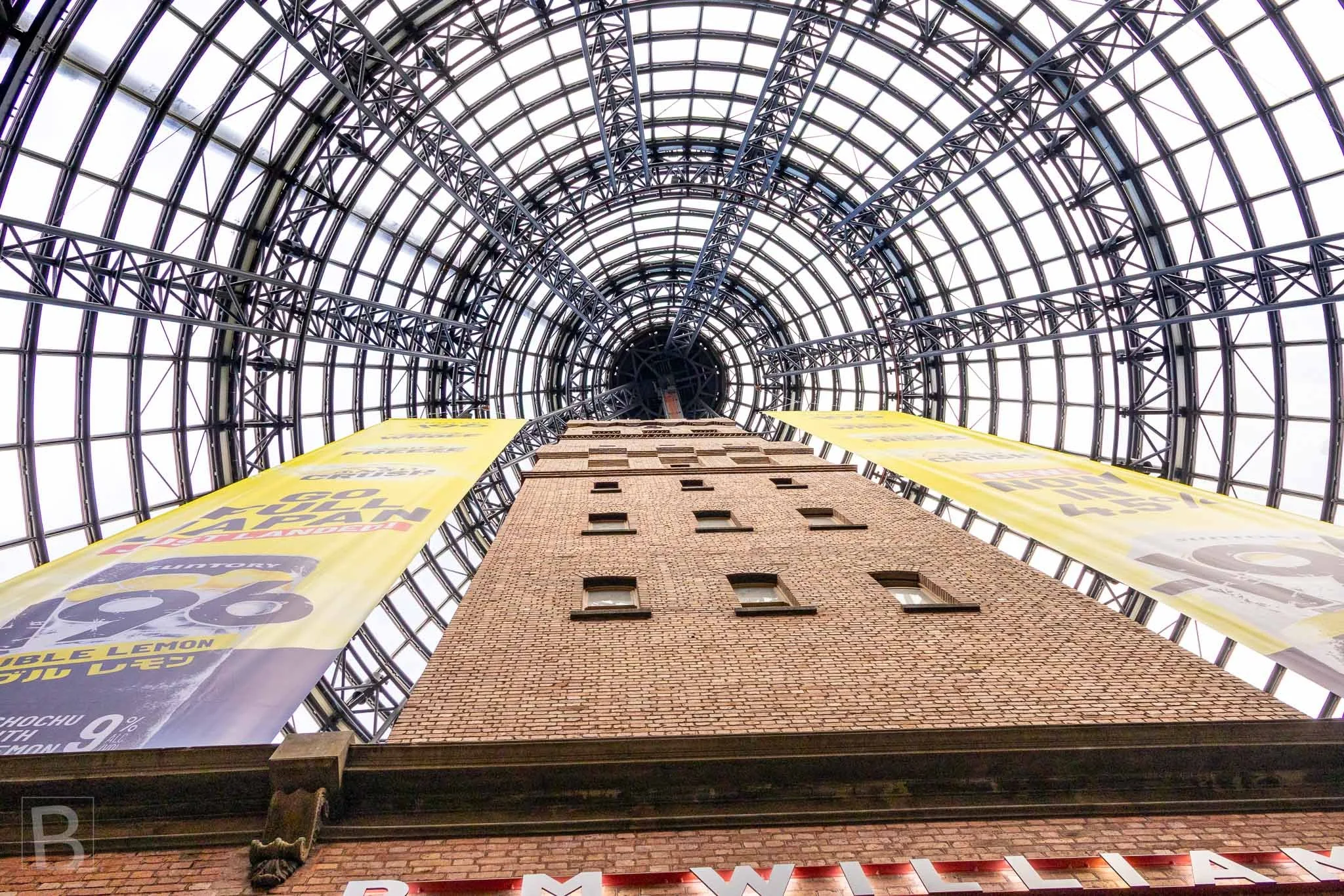 A nineteenth-century industrial tower is enclosed by a modern lattice
dome, creating one of Melbourne's most striking acts of architectural
preservation.