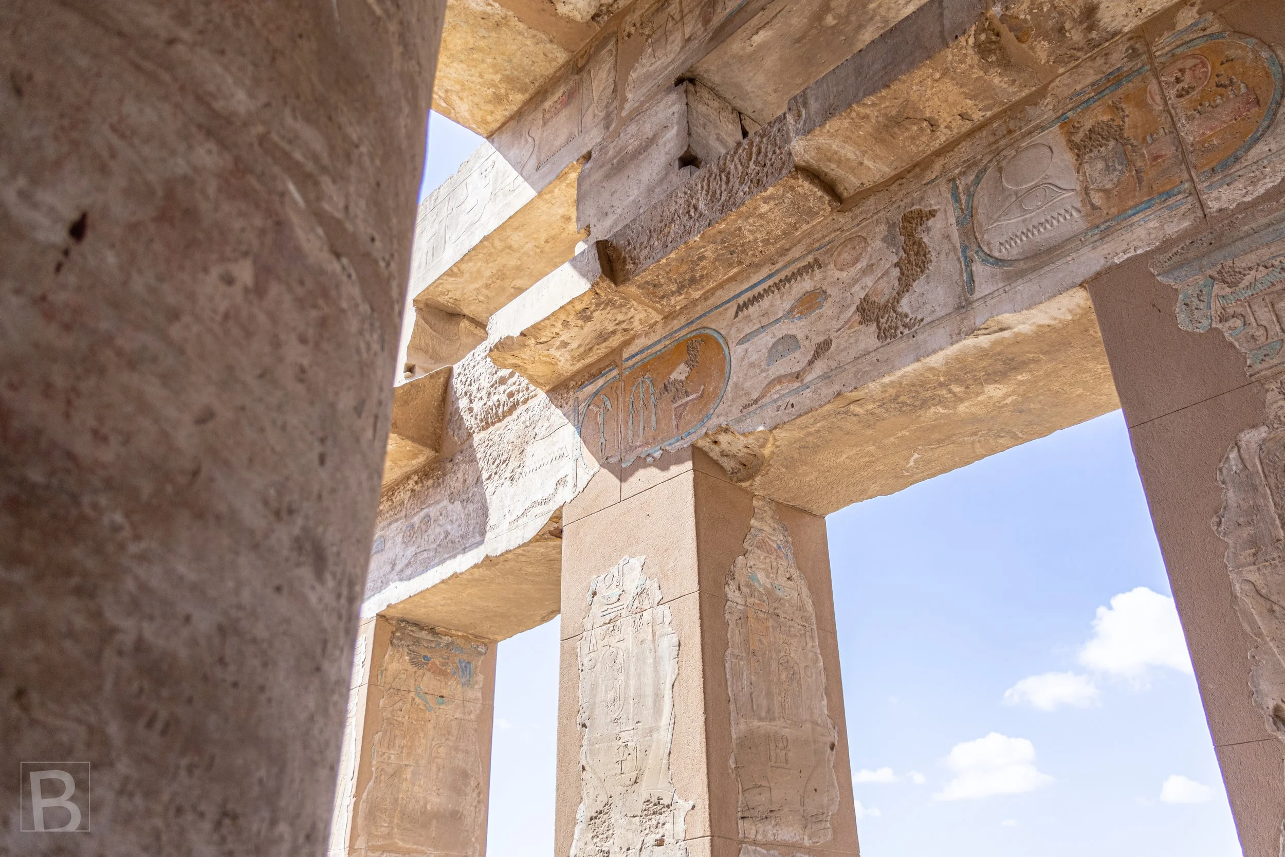 Carved lintels and pillars turn the open doorway into a layered record
of ritual, language and construction.