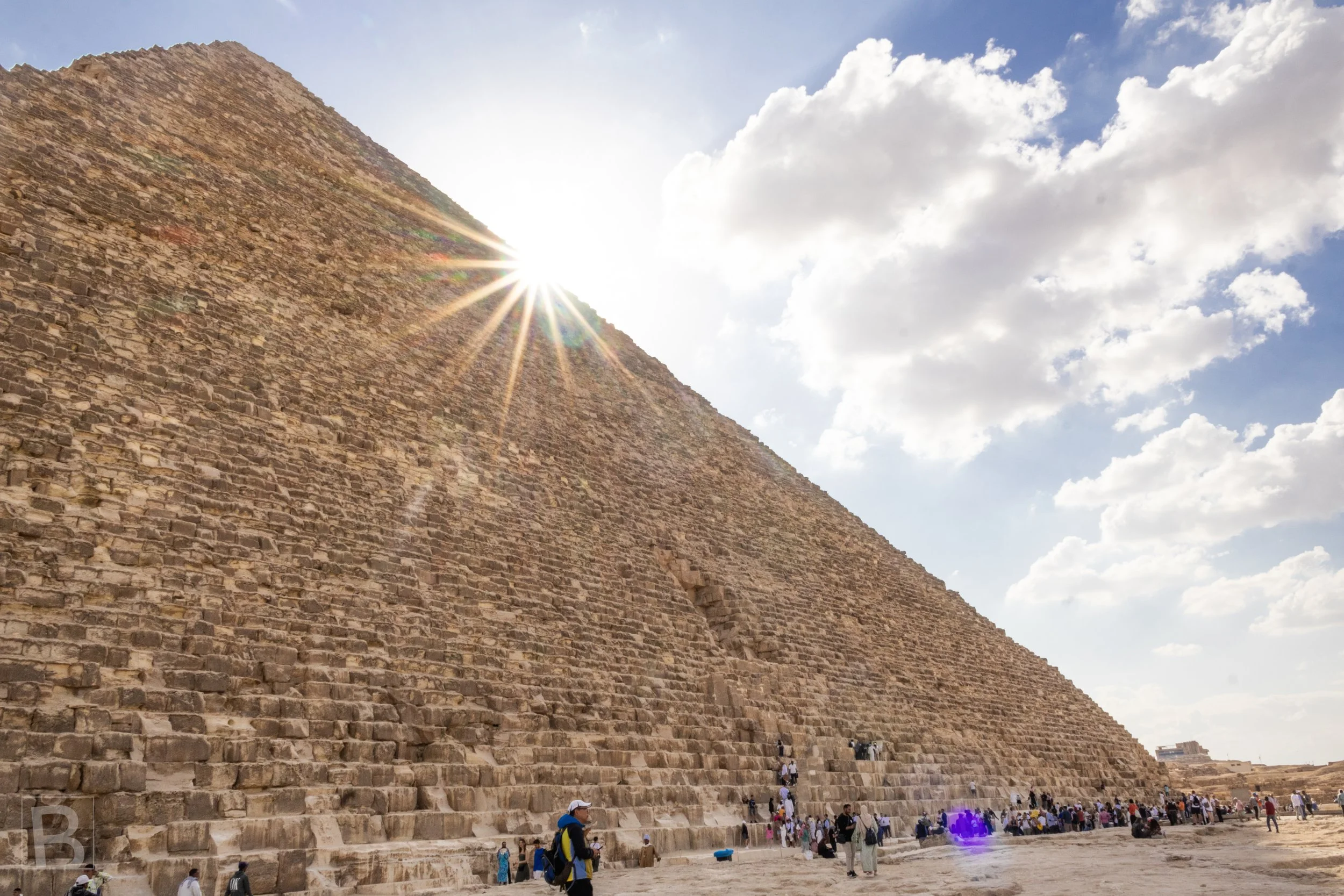 The sun catches the pyramid's vast stone face, emphasizing its
geometry and rough courses of masonry.