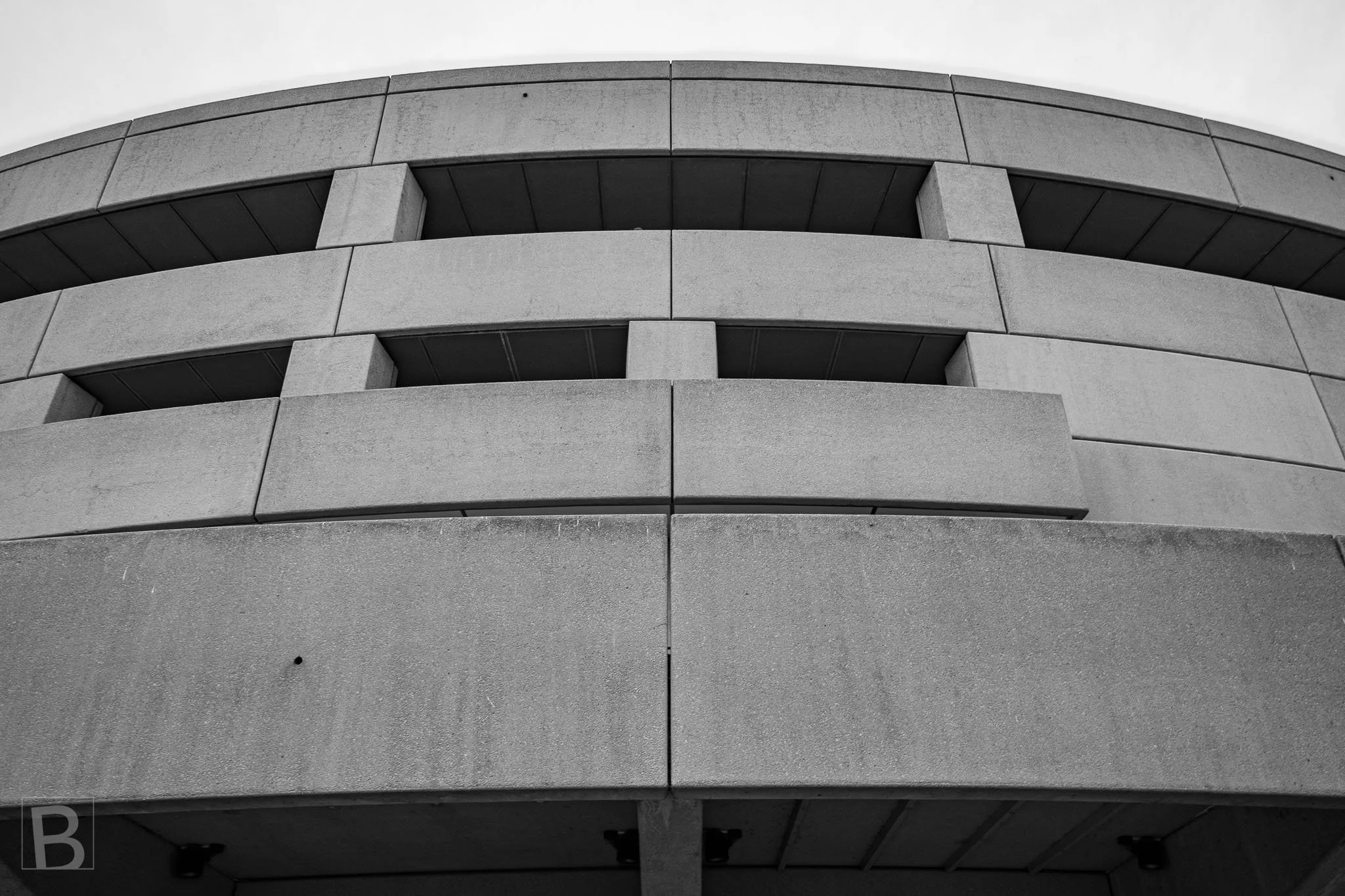The practical form of a multi-level car park becomes a study of
sweeping bands, deep openings and heavy concrete mass.