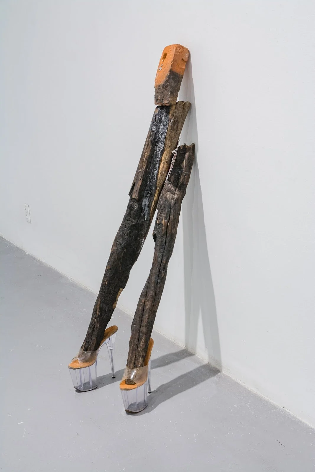Untitled4, 2021-2022
Materials: Two burnt logs, clear 8-inch Pleaser heels, soy wax, partially burnt brick, silicone caulk, ‘SEXY’ belly button piercing jewelry, monotype prints, Exotic magazine images, brick dust