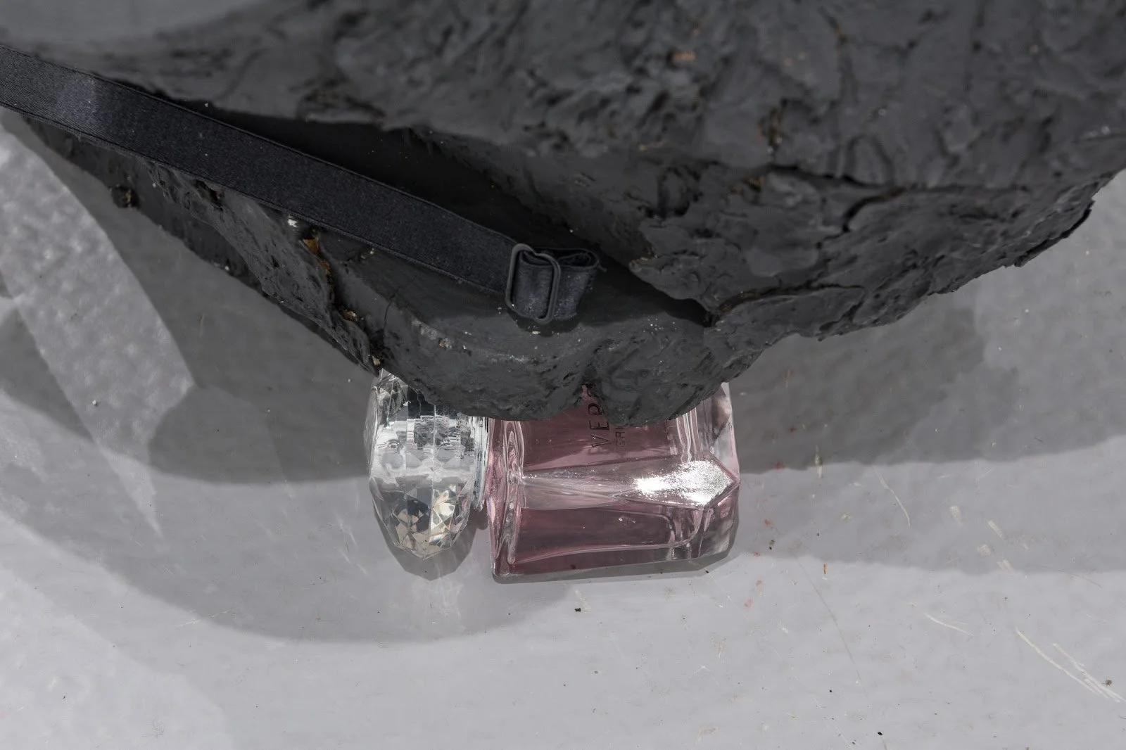 Untitled2 (close up image), 2022
Materials: Black 8-inch Pleaser heel, concrete, Pleaser heel bag, tree trunk, black acrylic paint, portable lock, black lace garter belt, Versace perfume bottle 