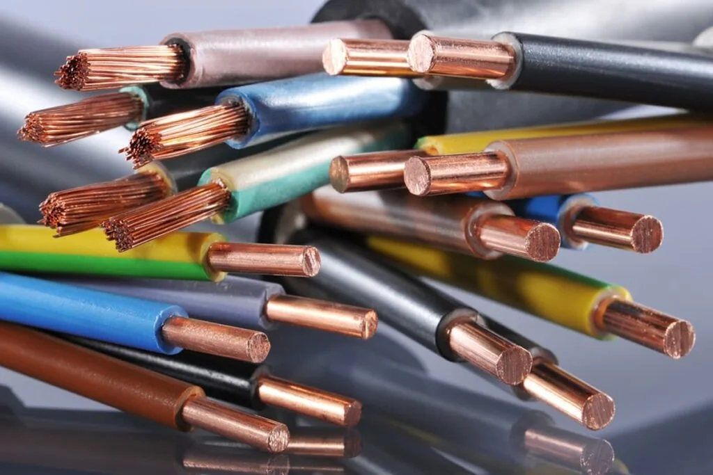Close-up of various colored electrical wires with exposed copper conductors.