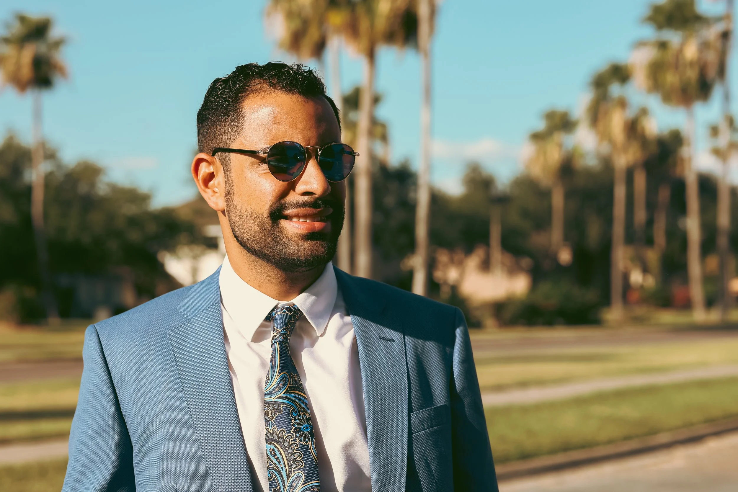 Sunglasses, tuxedo, and a blue sunny Texas sky.