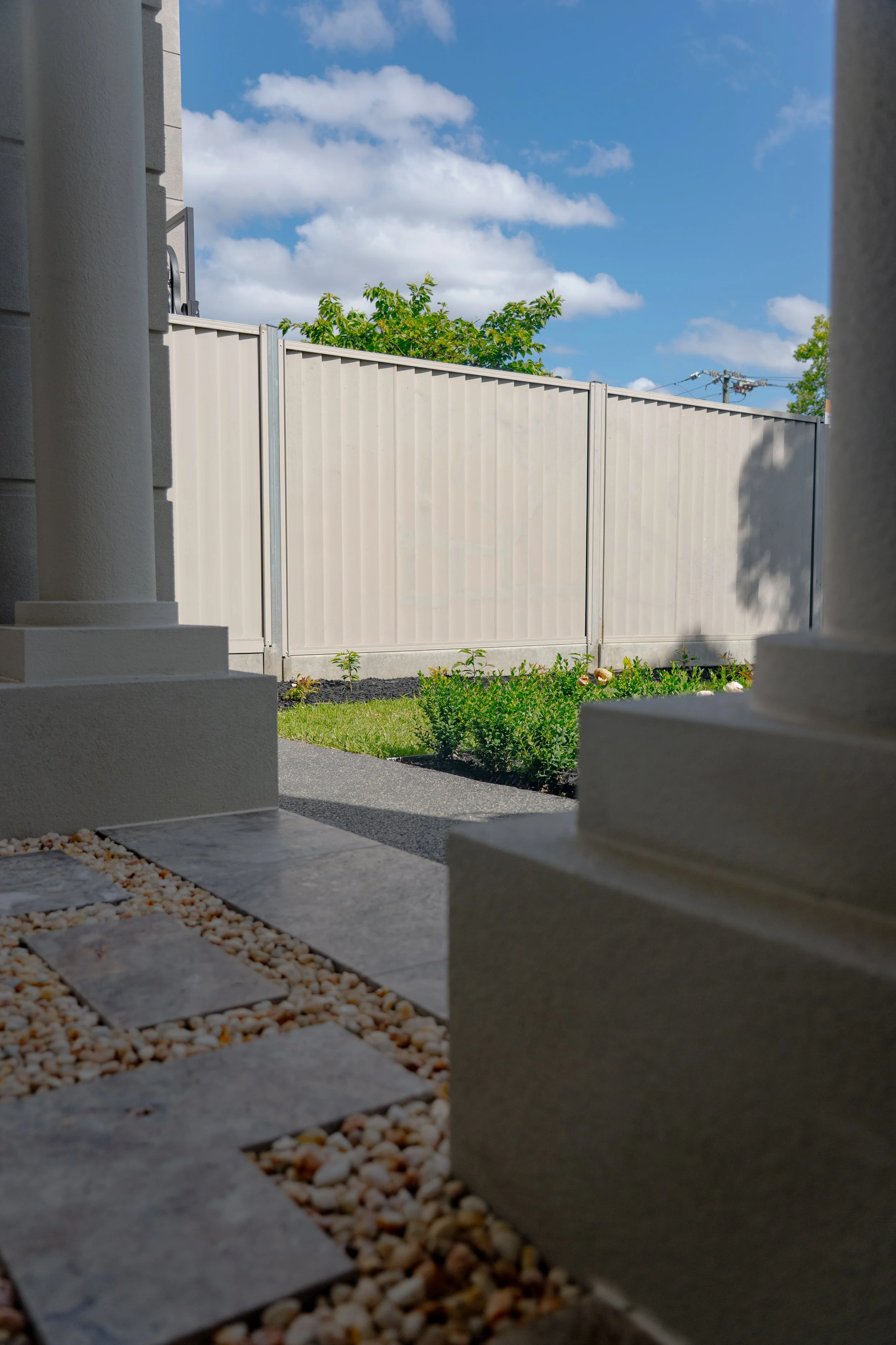 The bluestone paving steps and pebbles infill matching with the porch column, creating a leveled platform overlooking the garden.