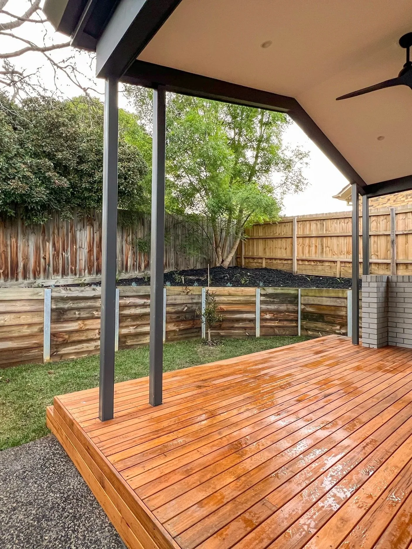 The outdoor timber deck looking at the raised garden bed, being a multi-functional open space.