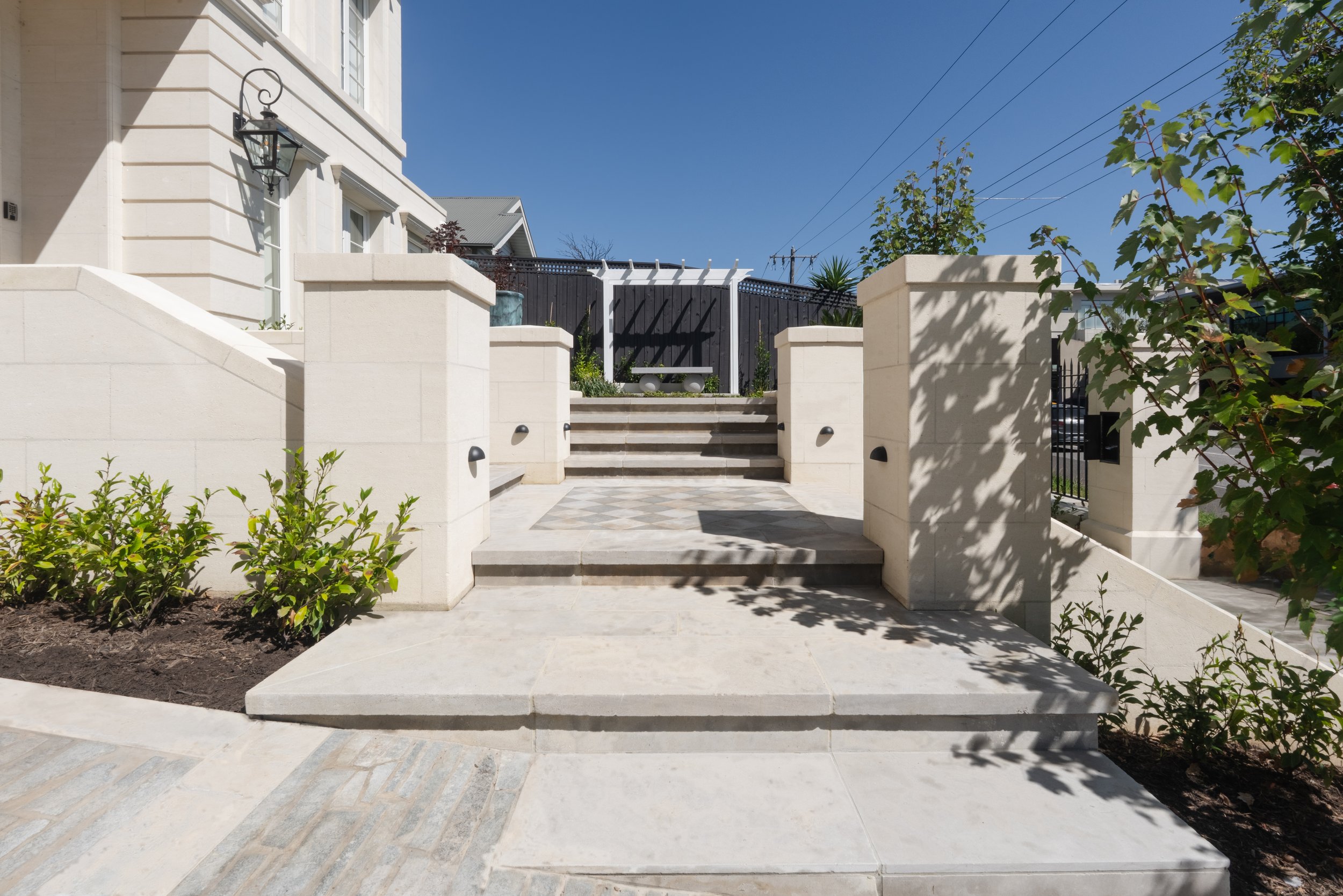 Lines of stone pavers used in the driveway groundwork, matching with the white pavers used in steps and adding texture to the garden.