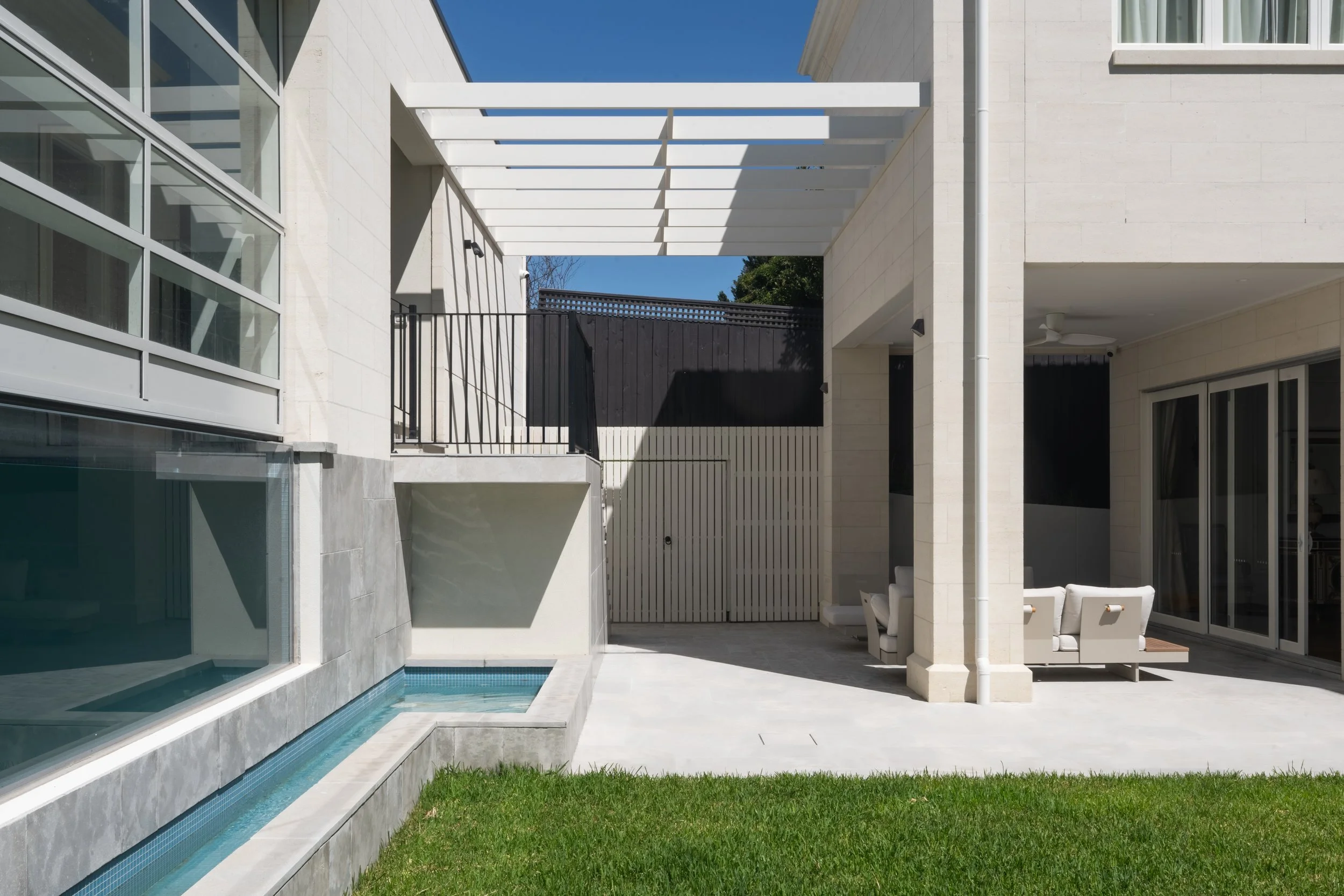 A mansion garden design and construction project, with a featured indoor pool and outdoor deck area, all pavings matched with architecture.