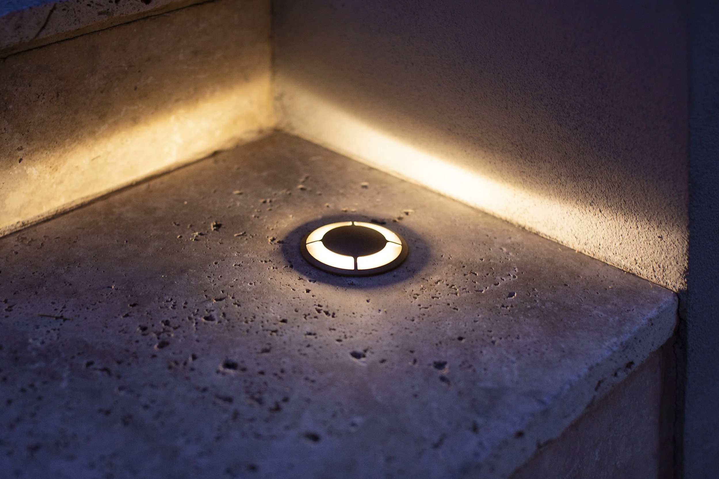 Outdoor floor led detail, lighting up the edges of the stone paved stairs, adding depth to the design.