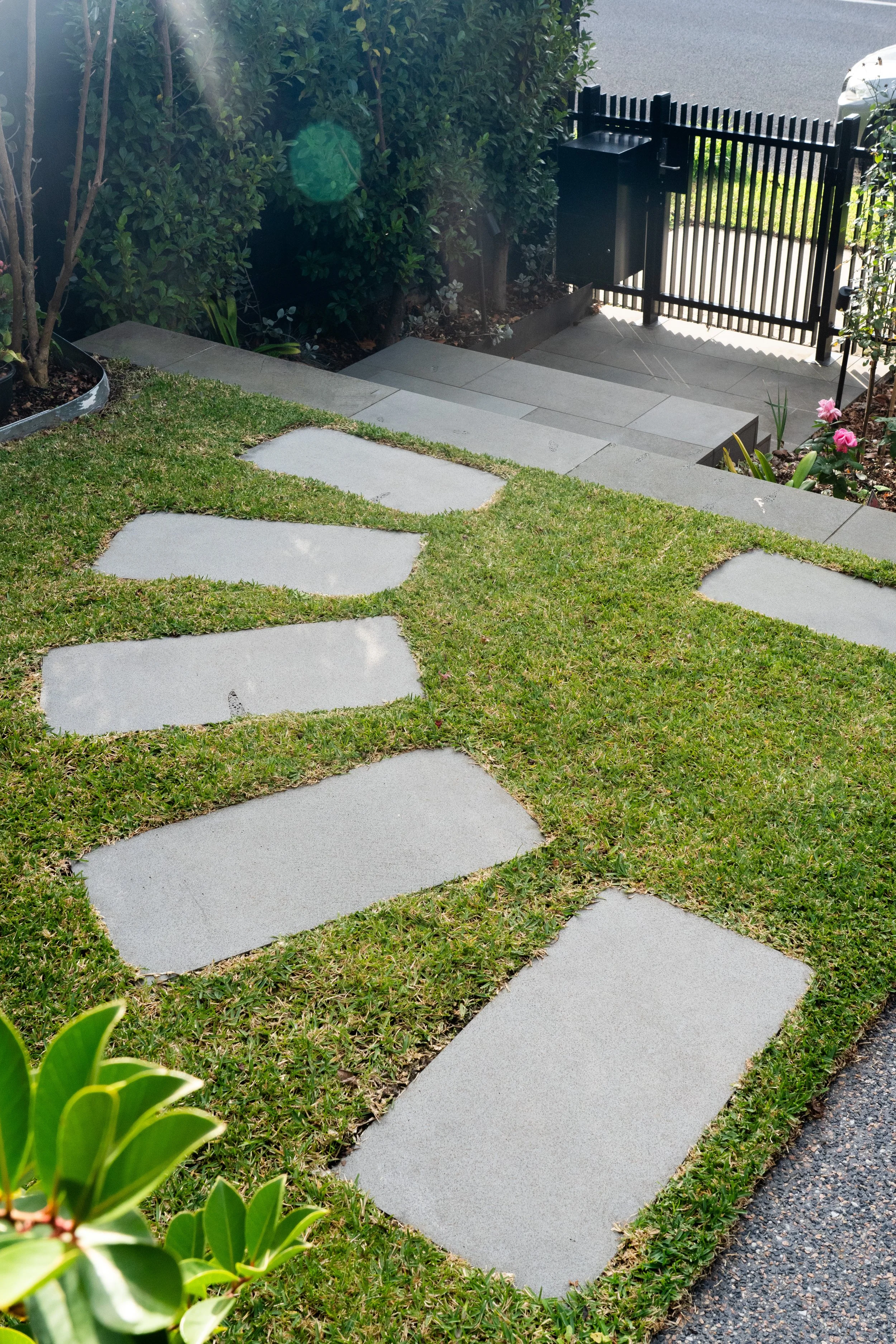 Bluestone pavings as stepping stones, creating a path from the entrance to the front porch.