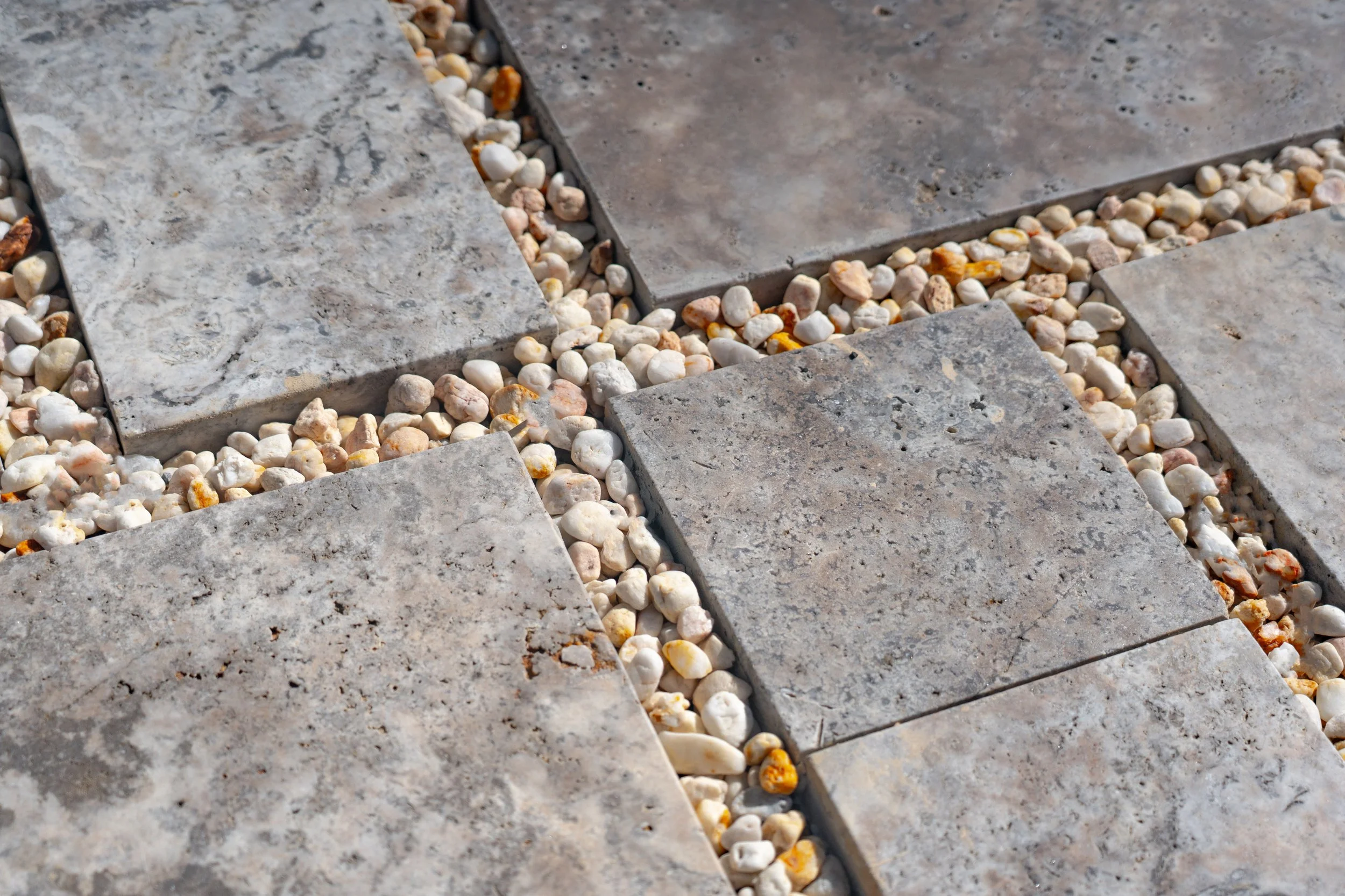 Detail shot of blustone paving steps and pebbles infill, creating natural patterns.