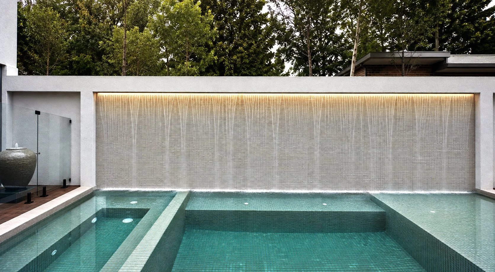 A garden design with a long strip of swim pools and water features like water wall.