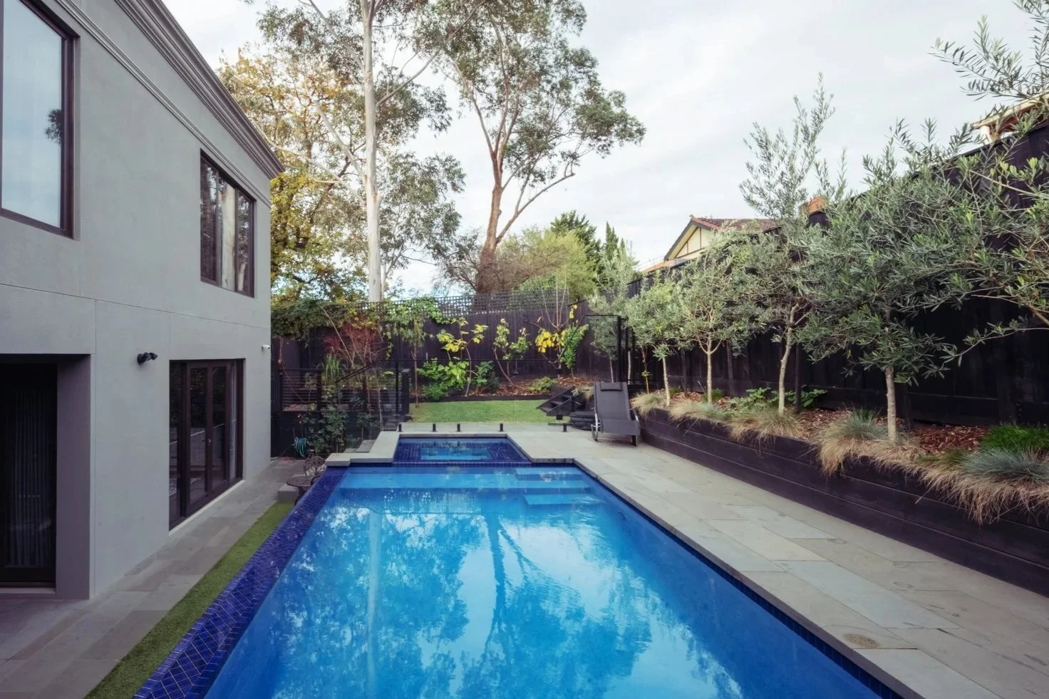 A mansion with a swim pool at backyard garden, showing the luxurious lifestyle.