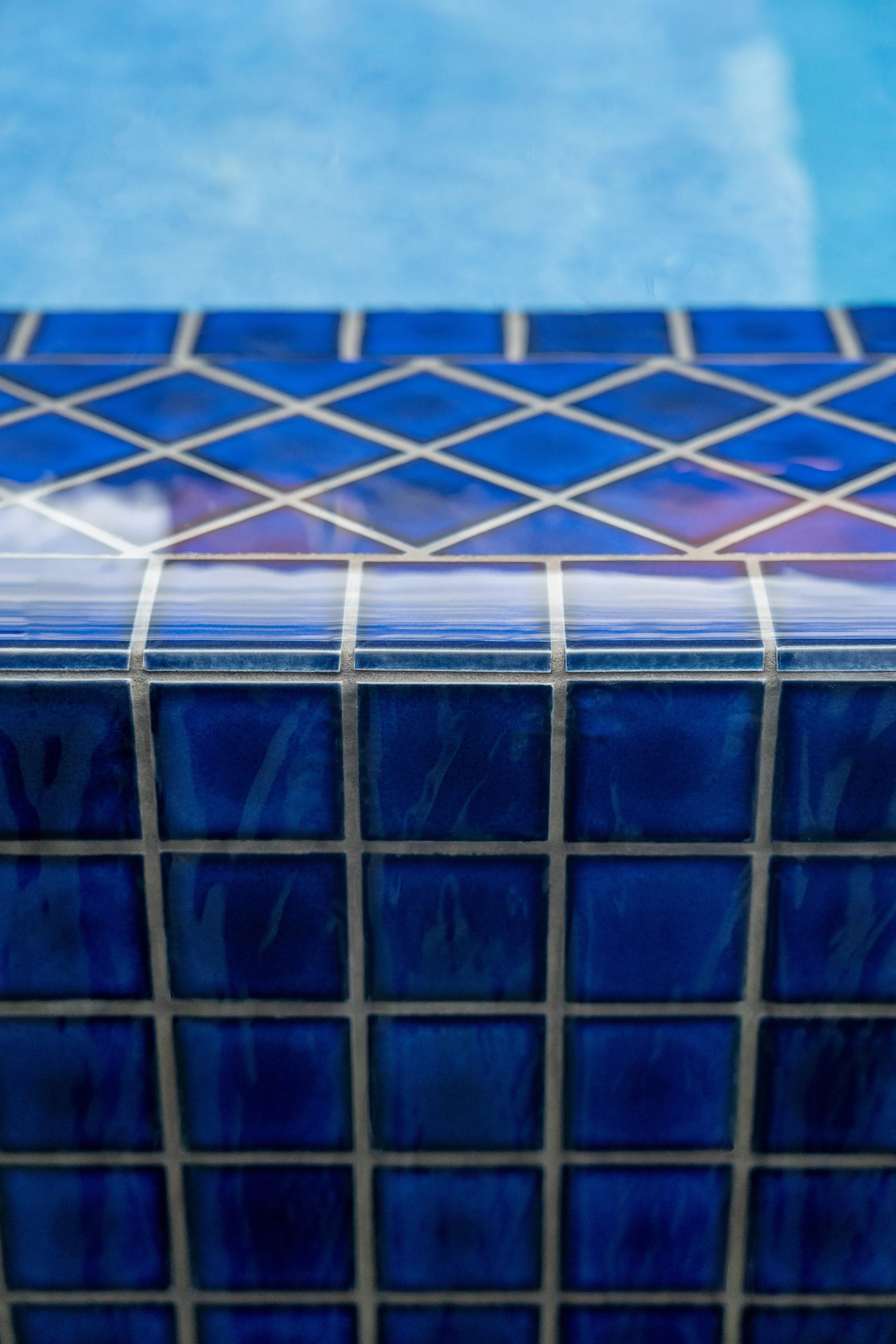 Close-up of a tennis court net with a blue surface in the background.
