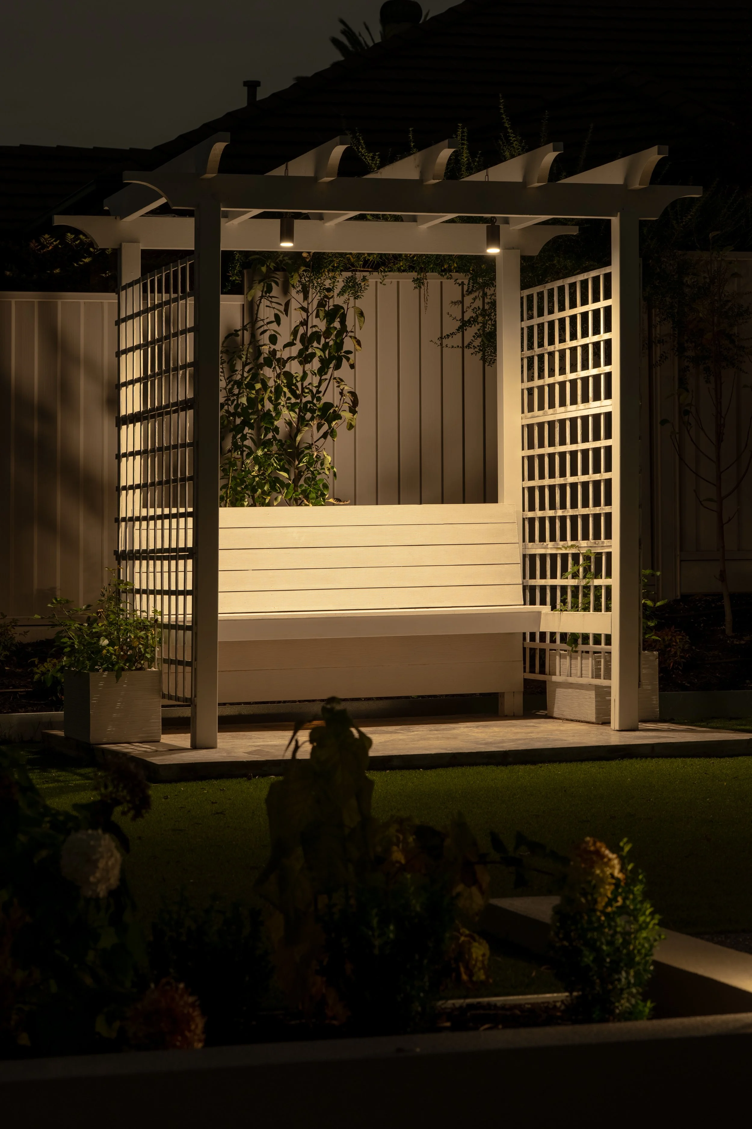 Led lighting creates a warm tone garden at night, lighting up the seating space, making a intimate outdoor area.