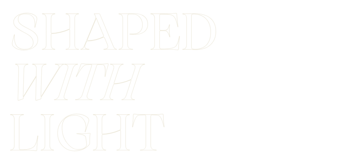 Text saying 'SHAPED WITH LIGHT' in stylized font against a black background.