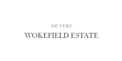Sign reading 'De Vere Wokefield Estate' in black text on a white background.