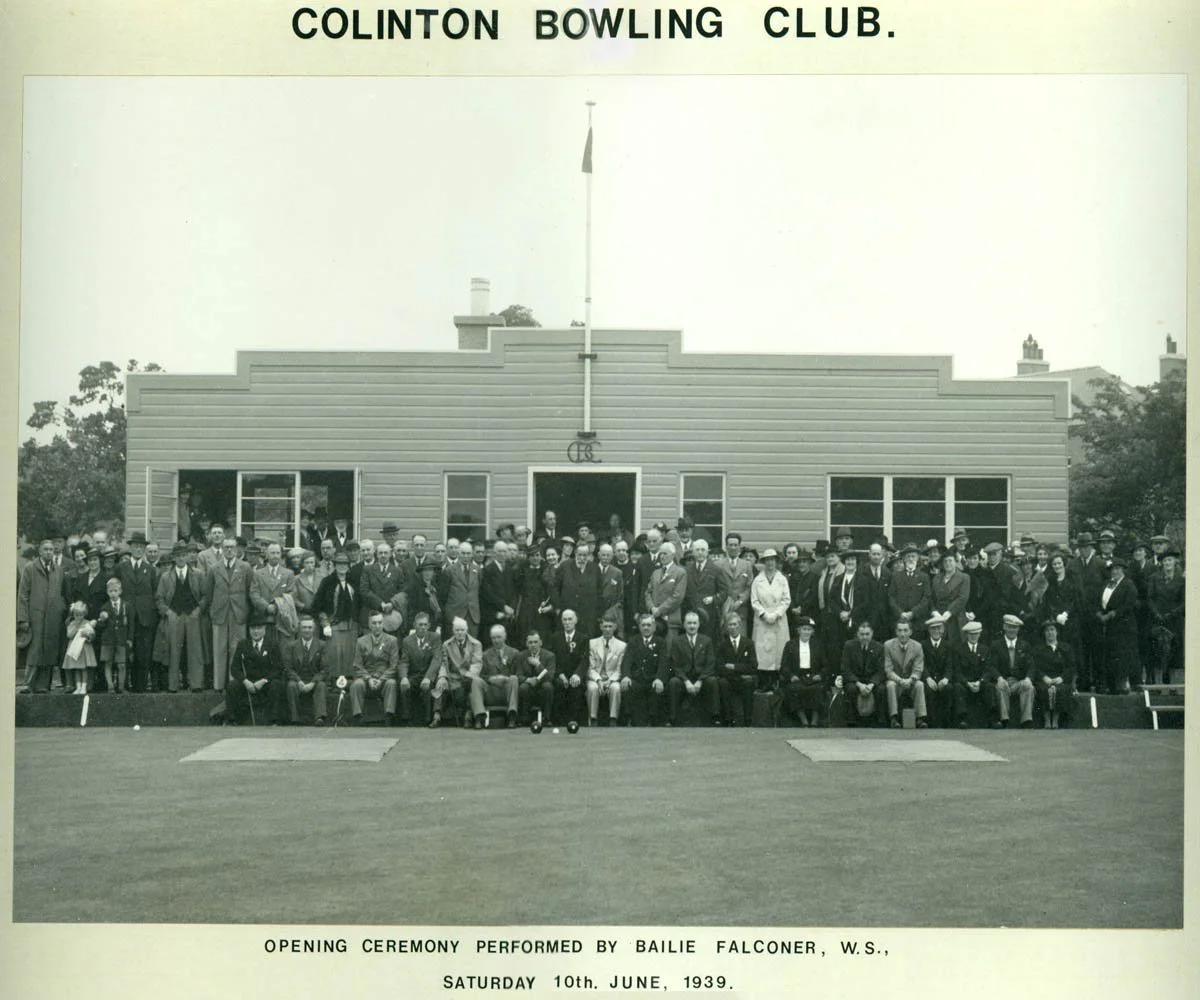 A black and white photograph of a large group of people posing in front of a building with a sign that reads "Colinton Bowling Club." The caption below states it is the opening ceremony performed by Bailie Falconer on June 10, 1939.