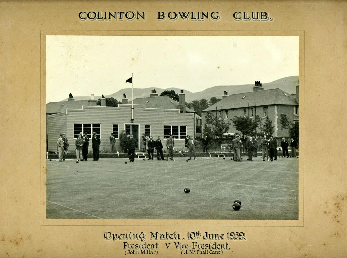 Historical black and white photograph of people playing lawn bowls at the Clinton Bowling Club during an opening match on June 10, 1939, with buildings and hills in the background.