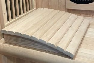 Unfinished wooden bed slats with a curved design resting on a wooden surface.