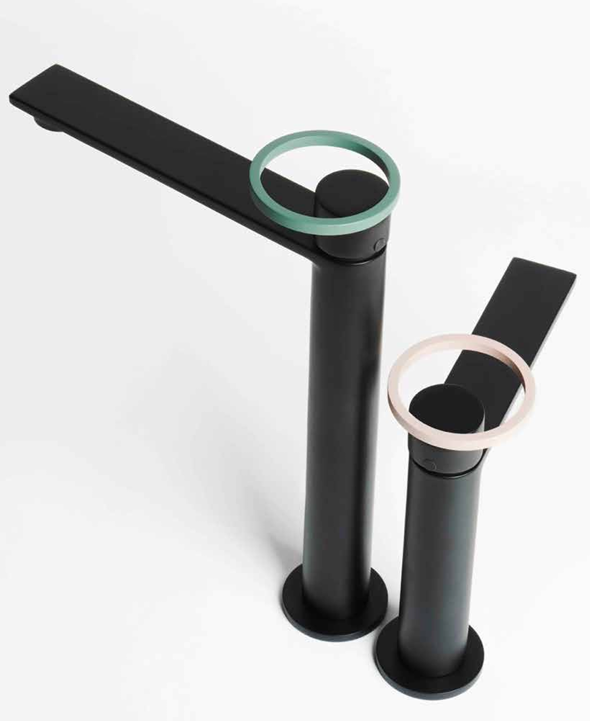 Two modern black faucet fixtures with circular handles, one larger with a green handle and one smaller with a pink handle, against a white background.