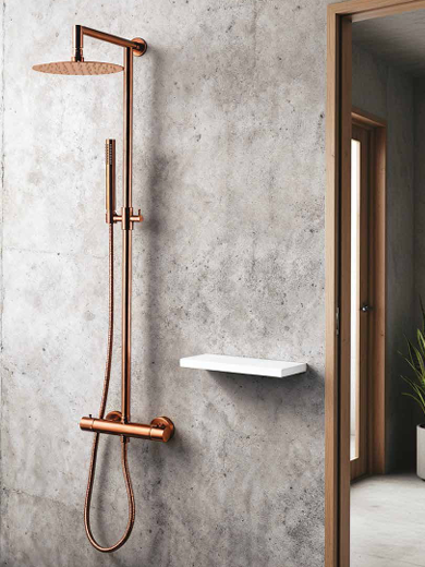 Modern shower with a copper rainfall showerhead, handheld shower, and a small white shelf on a concrete wall.