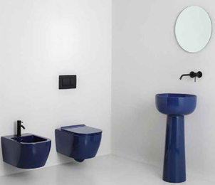 Bathroom with blue toilet, bidet, and pedestal sink, and a round mirror on the wall.