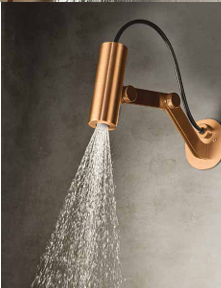 A modern wall-mounted faucet with a copper finish pouring water over a sink or surface.