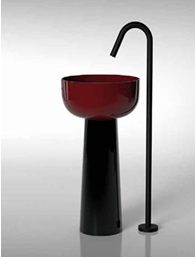 Modern red bowl on a black and silver stand with a tall curved black faucet