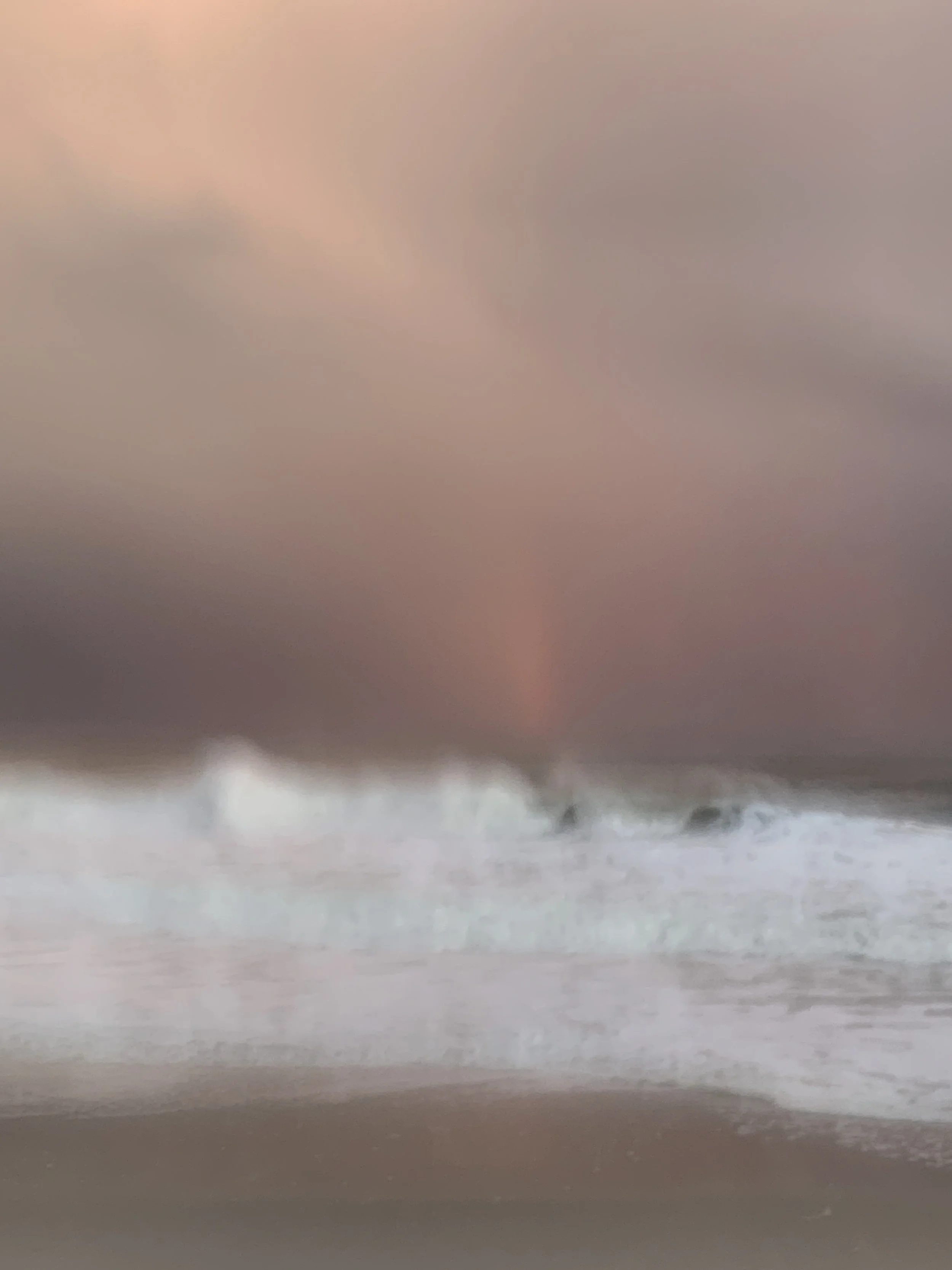 At the Edge of Light, Fire Island. Pink cloud drawn in diagonal streaks over white surf and wet sand.