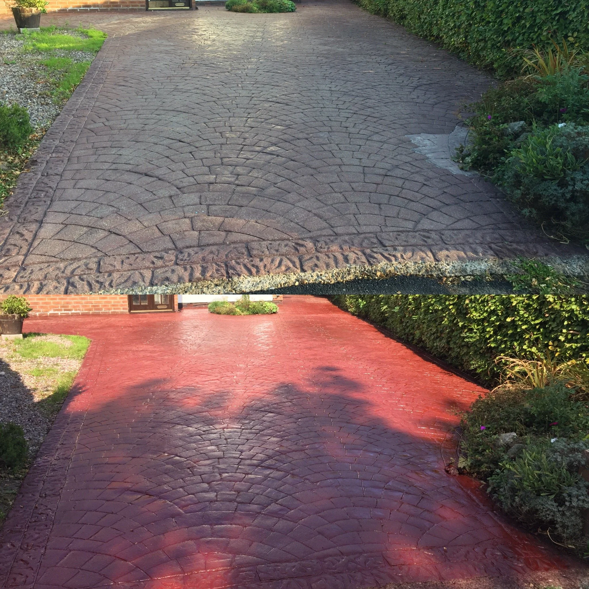 A red brick driveway with a curved pattern, bordered by bushes and plants on either side, leading to a house with a wooden door and a window.