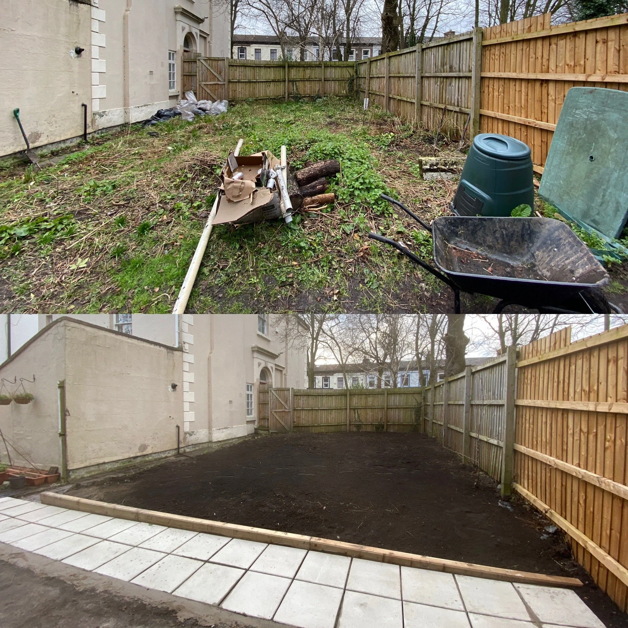 Backyard with new tiled patio, bare soil, wooden fence, house wall with some items stored against it, gardening tools and bag, log pile, and adjacent trees.