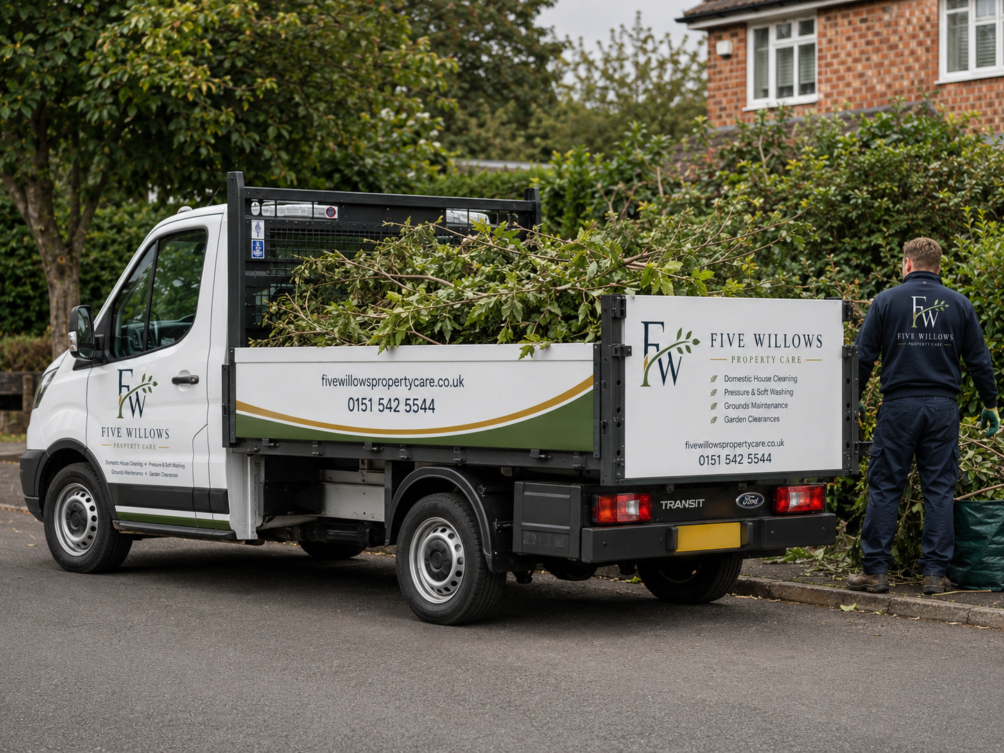 A white property care truck with green and gold accents parked on a residential street, with a man in a navy uniform standing next to a green bag and a pile of tree branches in the background. The truck displays the logo and contact information for Five Willows Property Care.