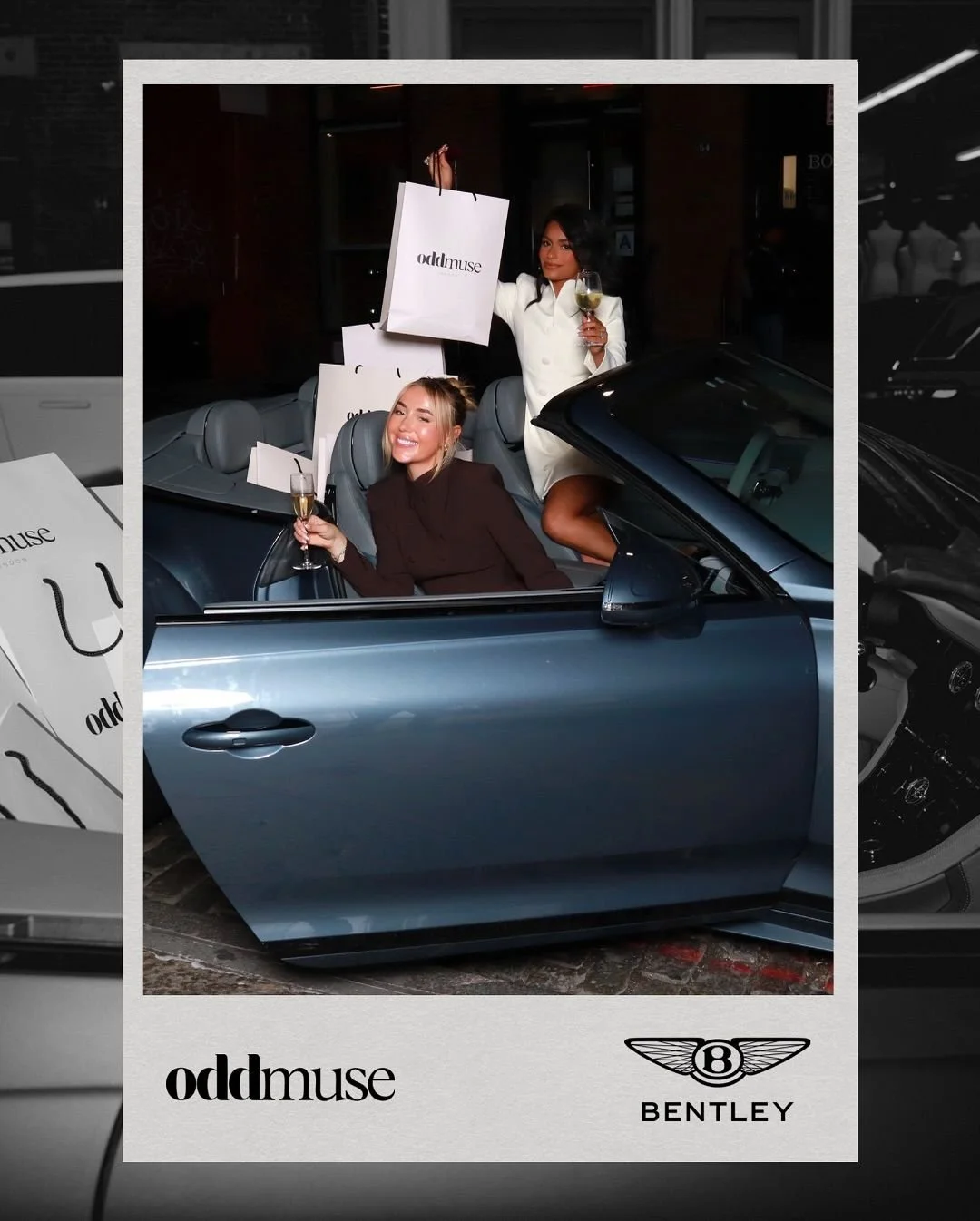 Two women celebrating with glasses of champagne inside a blue convertible car, with shopping bags labeled 'oddmuse,' against a dark background.